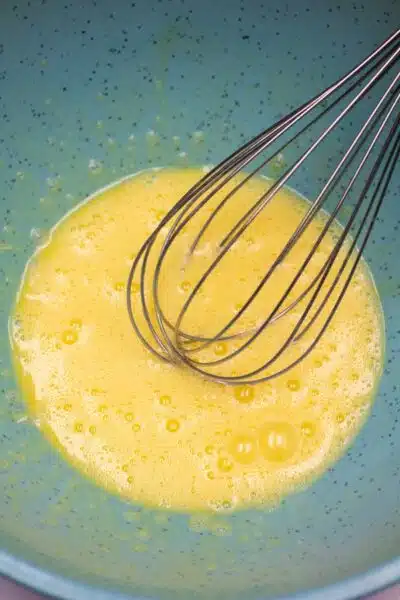 Process image 2 showing whisked eggs in a mixing bowl.