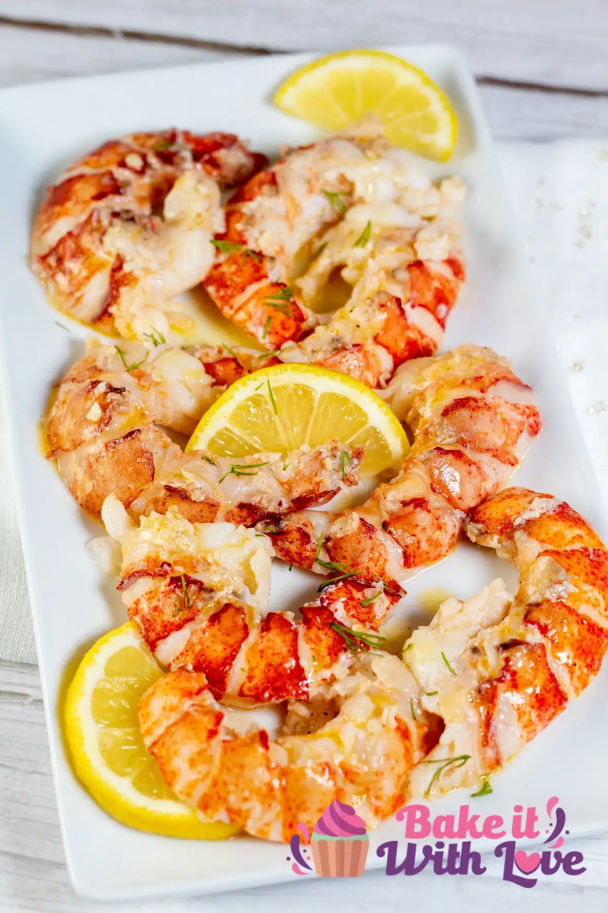 Tall image showing butter poached lobster tails.
