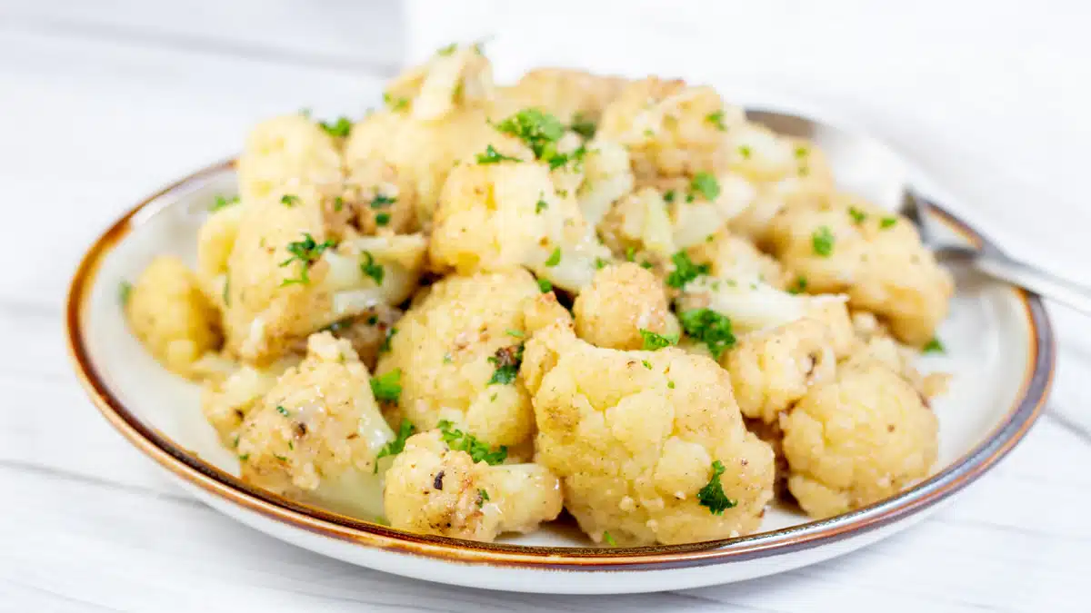 Wide image of a plate of sauteed cauliflower.