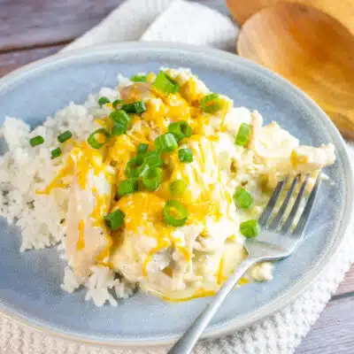 Square image of slow cooker Ranch chicken over white rice.