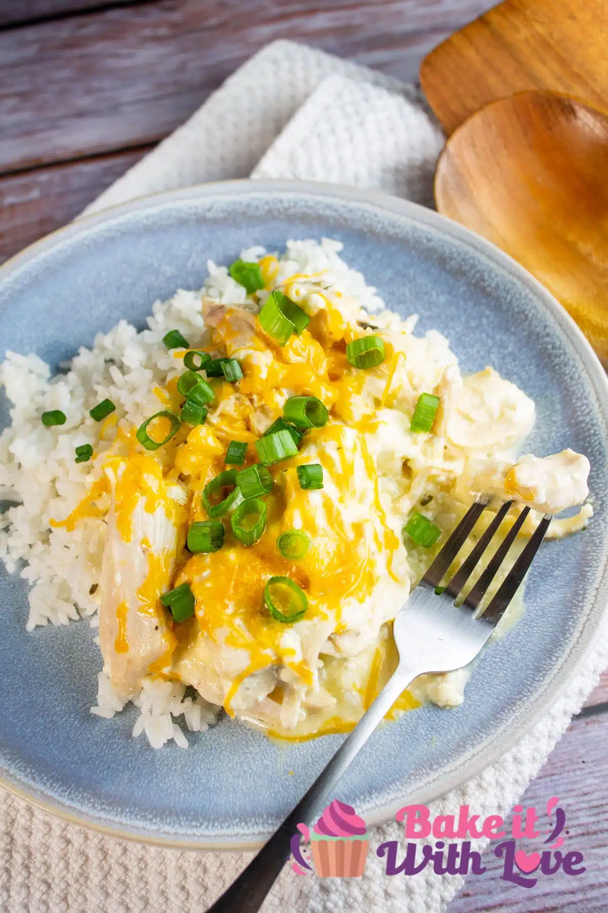 Tall image of slow cooker Ranch chicken over white rice.