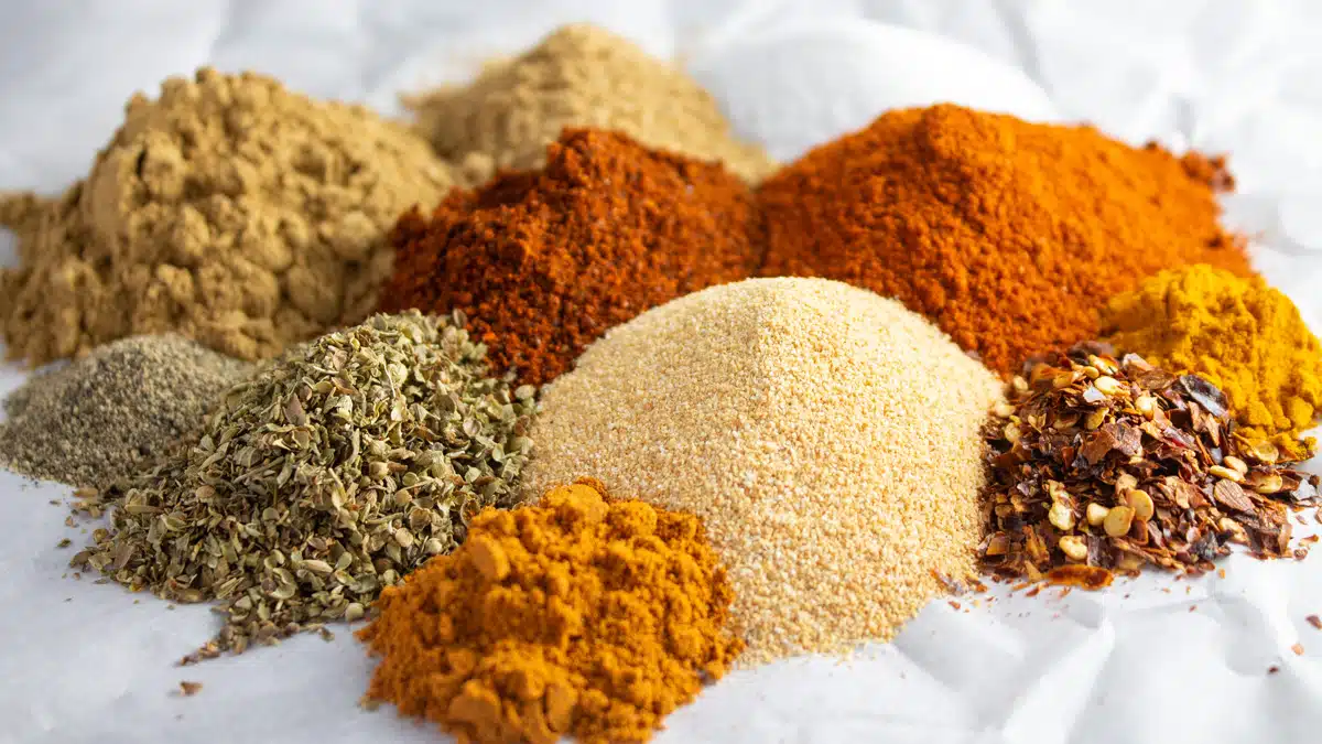 Wide image of Southwest seasoning ingredients on a white background.