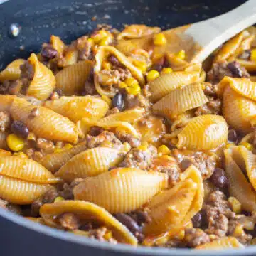 Wide image of taco pasta in a large skillet.