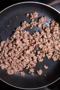 Process image 2 showing ground beef browned in a skillet.