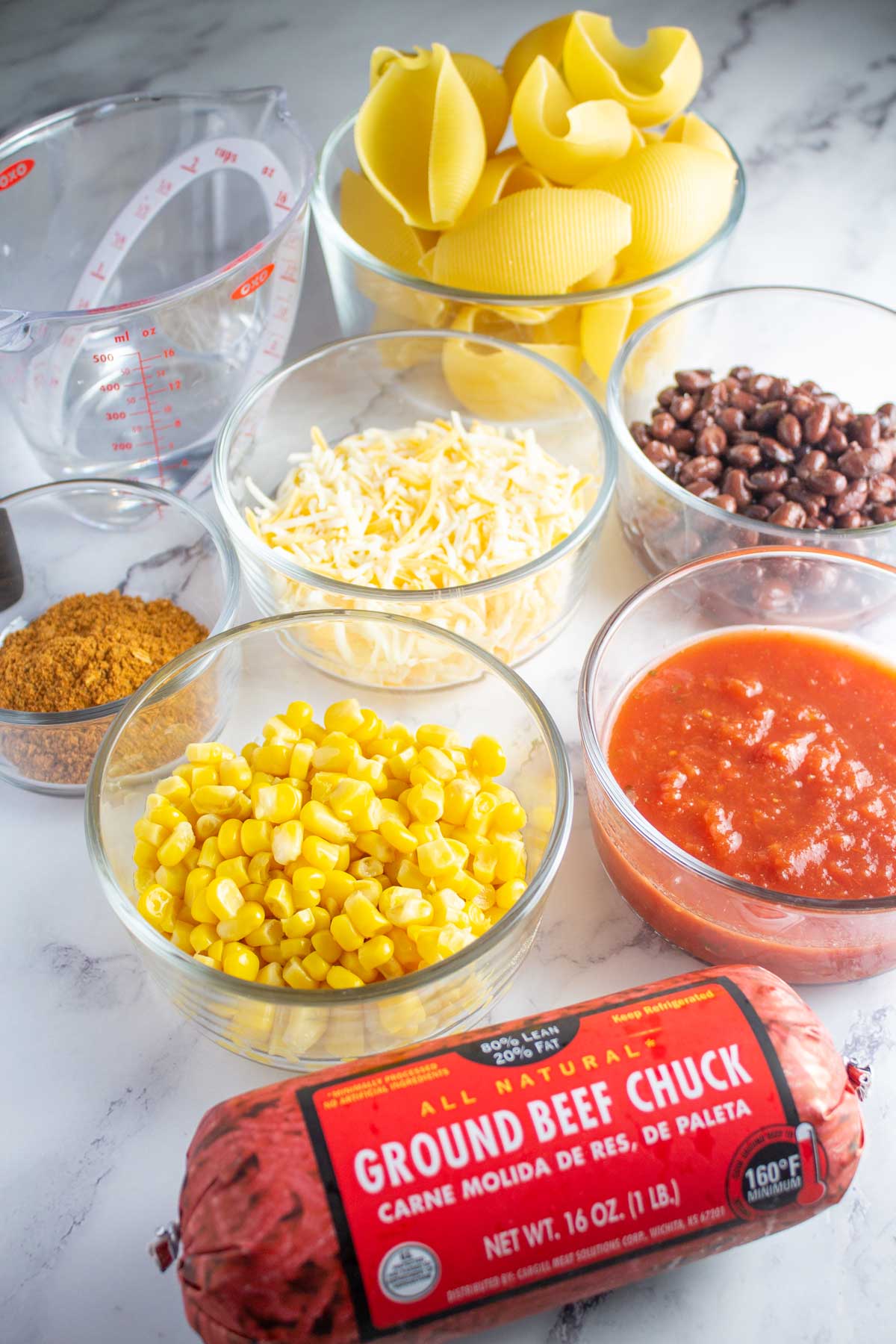 Tall image showing taco stuffed shell ingredients.