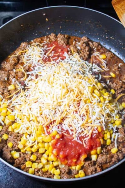 Process image 4 showing added corn, beans, salsa, and cheese.