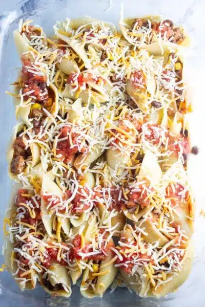 Process image 8 showing stuffed pasta shells in a baking dish with added cheese.