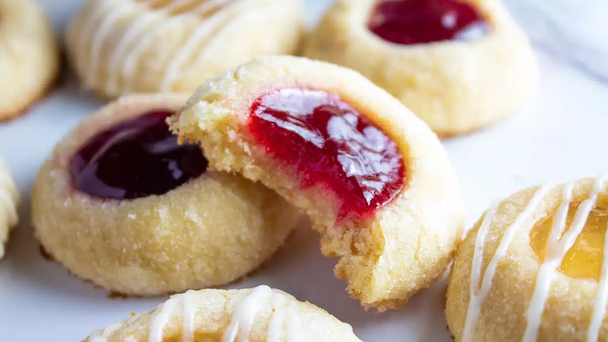 Wide image of thumbprint cookies on a plate.