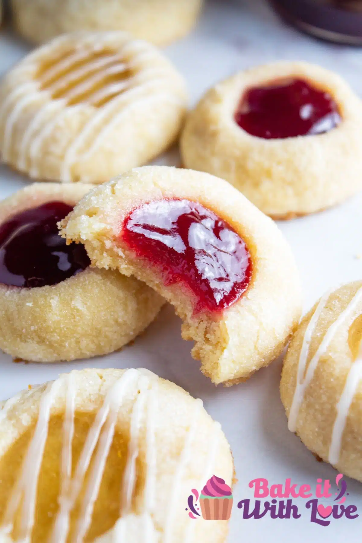 Tall image of thumbprint cookies on a plate.