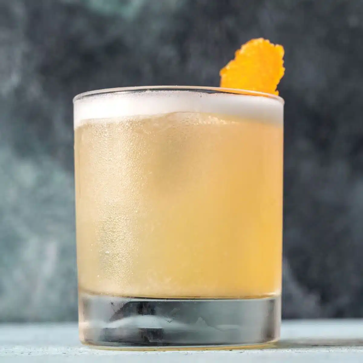 Square image of a whiskey sour mocktail.