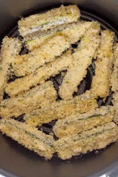 Process image 5 showing coated zucchini in the air fryer.