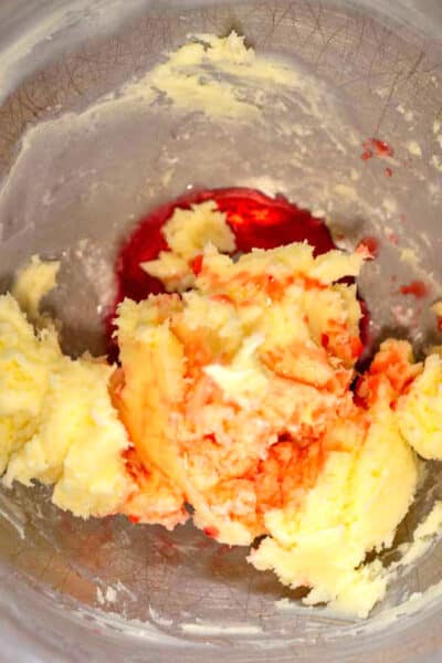 Process image 2 showing butter and sugar creamed together in mixing bowl with cherry extract.