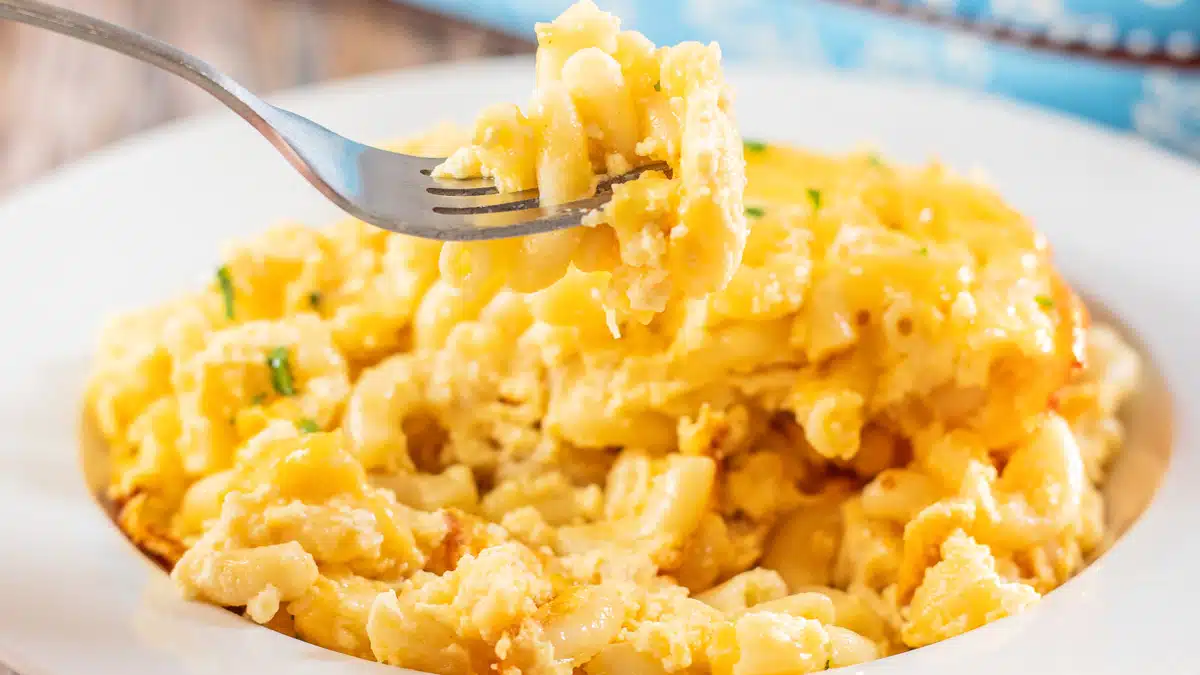 Wide closeup on a serving of Paula Deen's baked mac and cheese in a white pasta bowl.