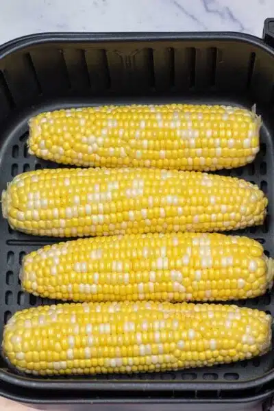 Process image showing corn in the air fryer.