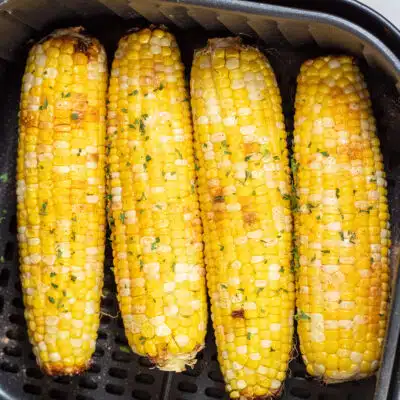 Square image of air fryer corn on the cob.