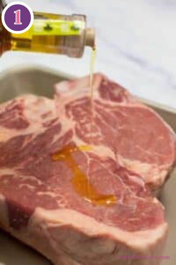 Bistecca alla fiorentina process photo 1. A bottle of olive oil is pouring oil onto a thick cut of raw Bistecca alla Fiorentina (T-bone or porterhouse steak) in a baking pan. A purple circle with the number '1' is in the top left corner.