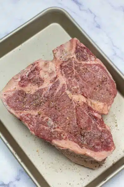 Process image 3 showing added seasoning on steak.
