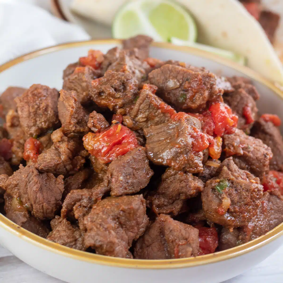Tasty carne picada beef with seasoning and tomatoes ready to make tacos, burritos, enchiladas, and more.