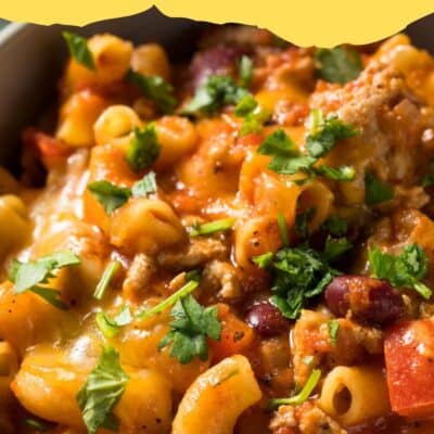 Pin image with text of chili mac in a bowl.