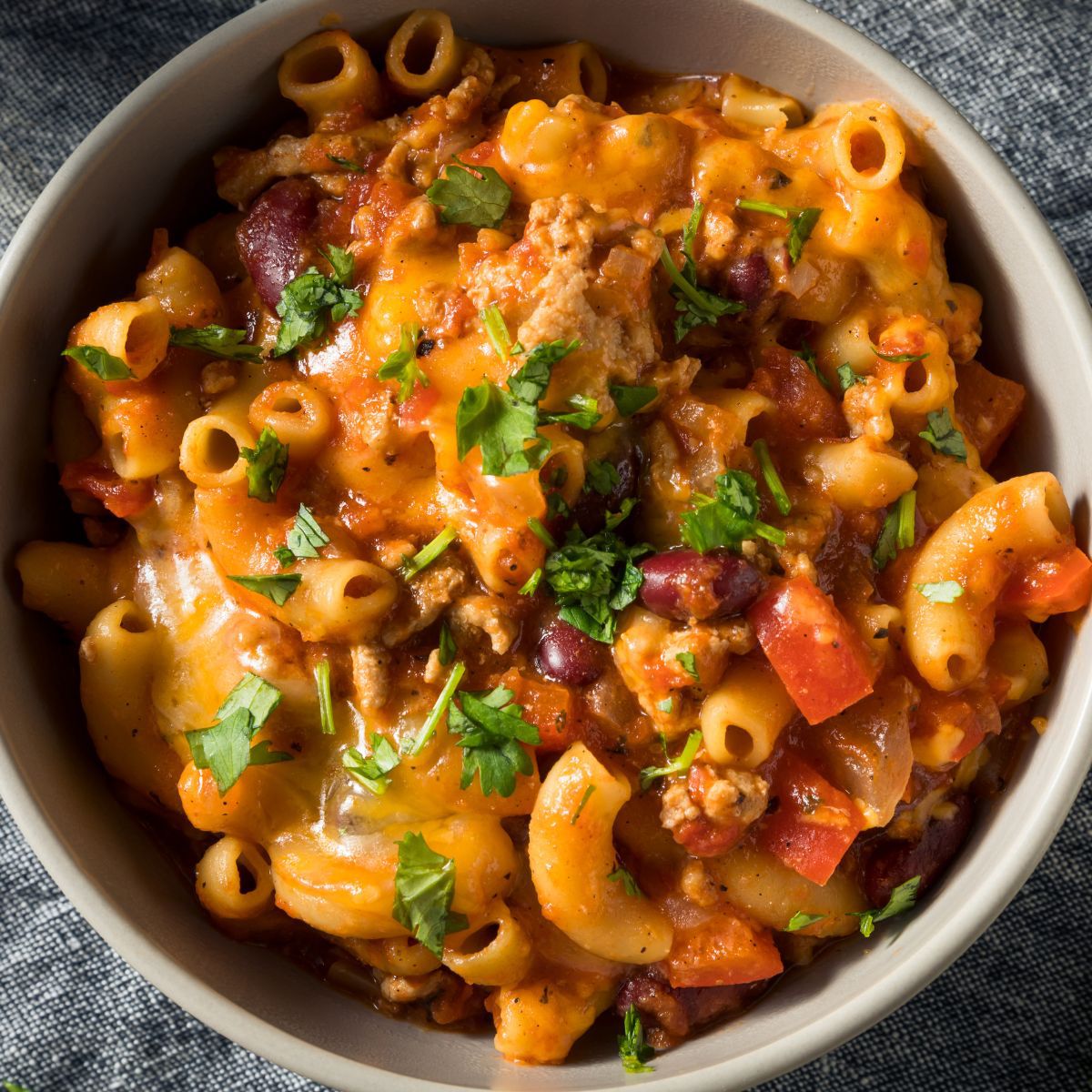 Square image of chili mac in a bowl.