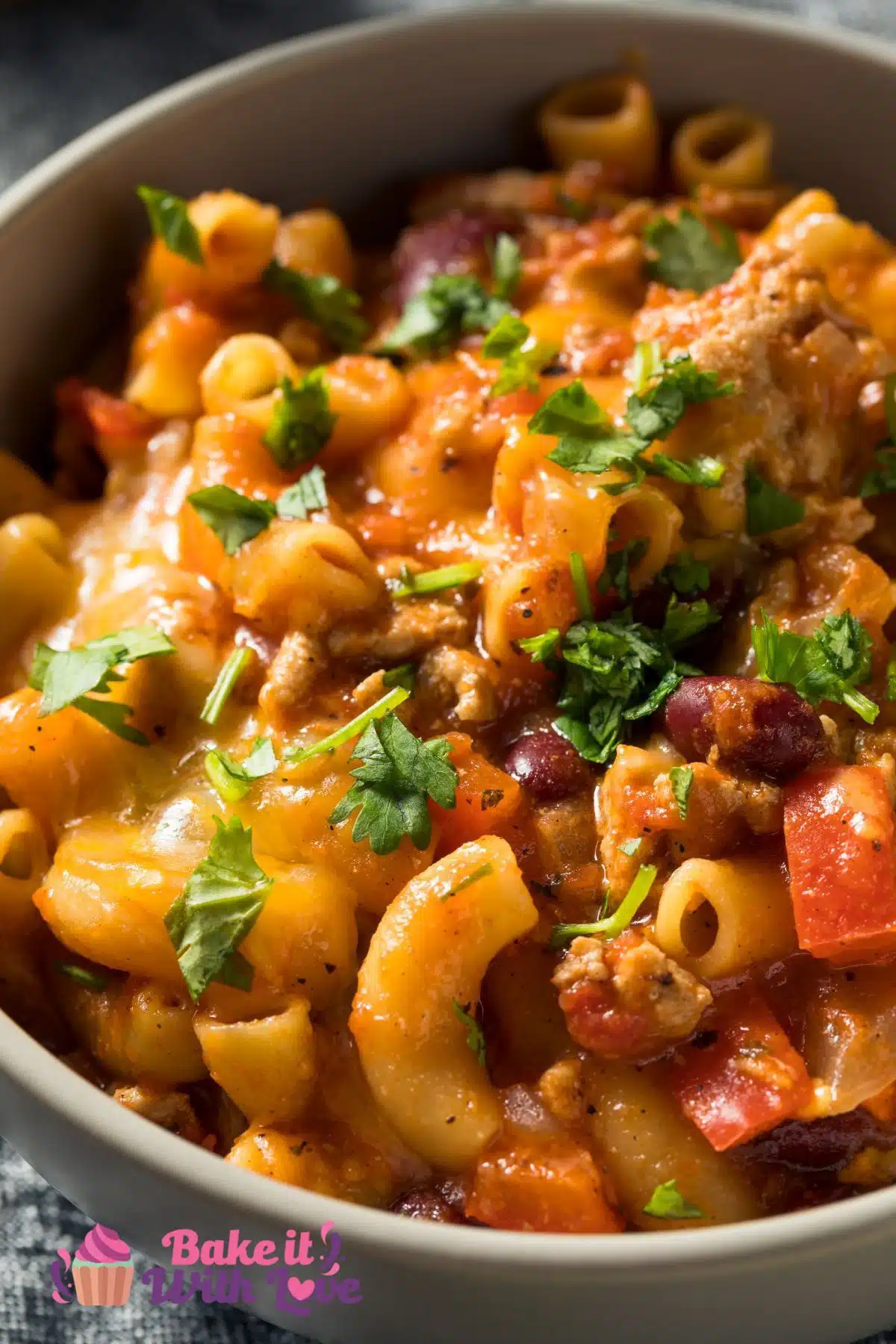 Tall image of chili mac in a bowl.