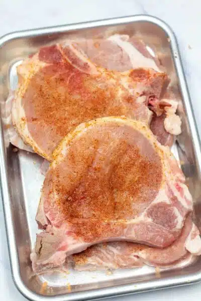 Process image 1 showing seasoned pork chops.