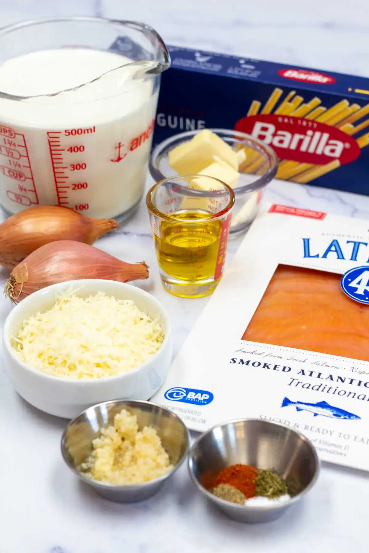 Tall image of creamy salmon pasta ingredients.