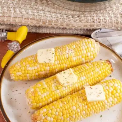Tall image of microwaved corn on the cob.