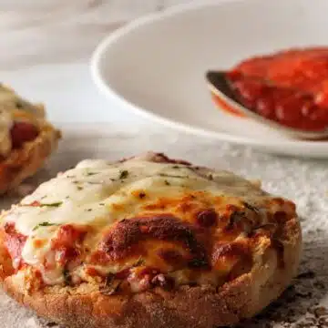 Wide image of English muffin pizzas.