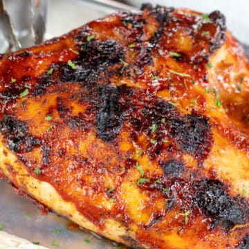 Wide image of grilled BBQ chicken breast.