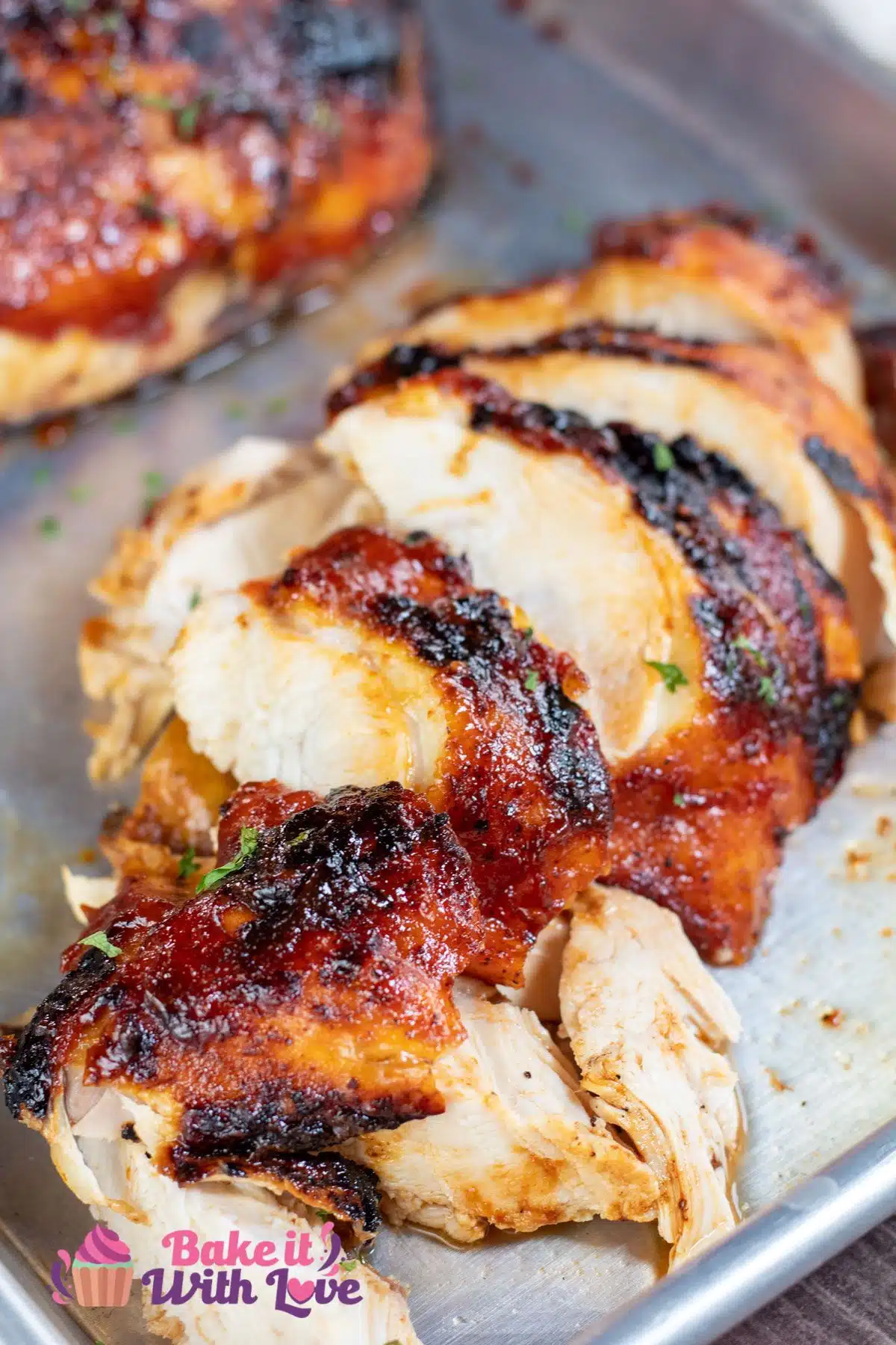 Tall image of grilled sliced BBQ chicken breast.