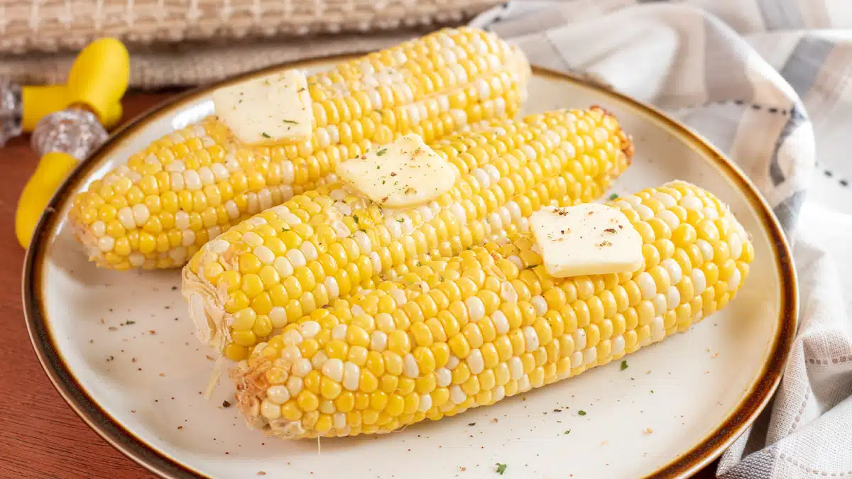 Wide image of microwaved corn on the cob.