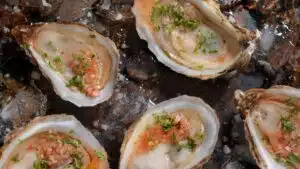 Wide image of oysters with Mignonette sauce.