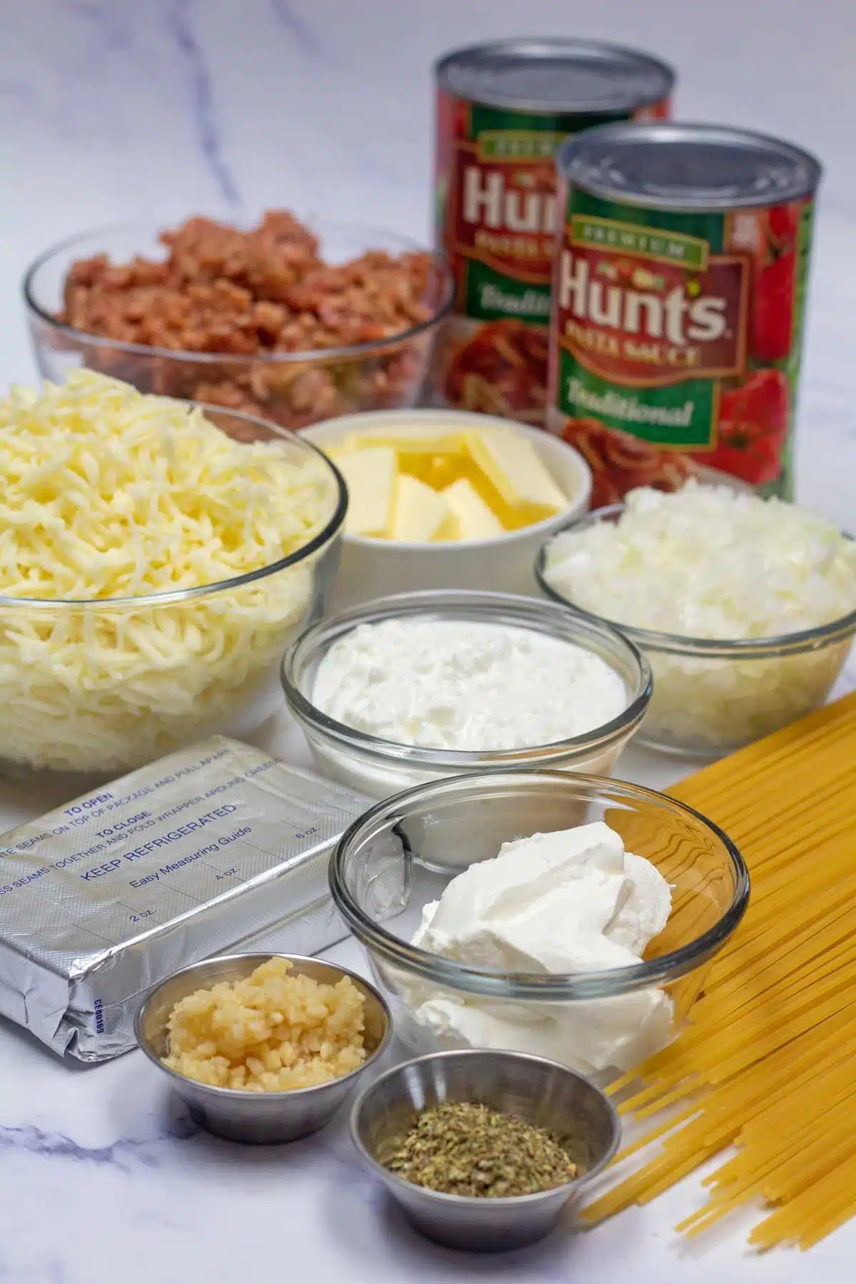 Tall image showing ingredients needed for Million dollar spaghetti casserole.