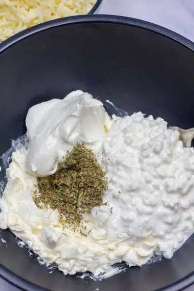Process image 6 showing cottage cheese, cream cheese, and seasoning in a mixing bowl.