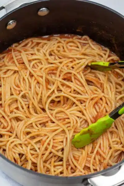 Process image 8 showing noodles tossed with sauce.