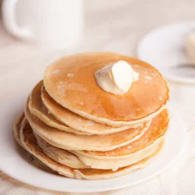 Square image of a stack of pancakes made without eggs.