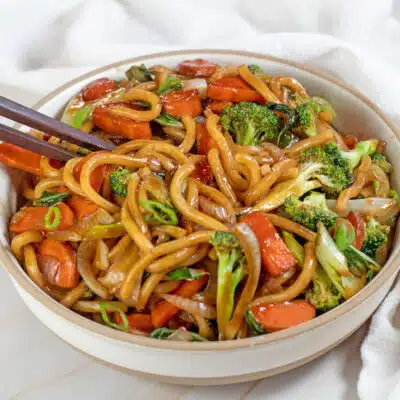 Square image of yaki udon, stir fry udon noodles in a bowl.