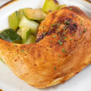 Wide image of air fried chicken leg quarters.