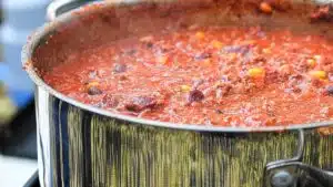 Wide image of chili sauce for hot dogs.