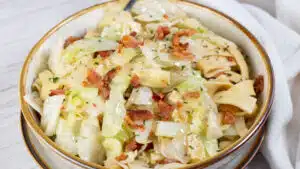 Wide image of cabbage and noodles.