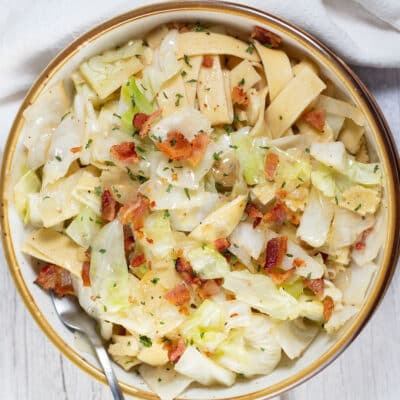Square image of cabbage and noodles.