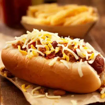 Square image of chili dogs.