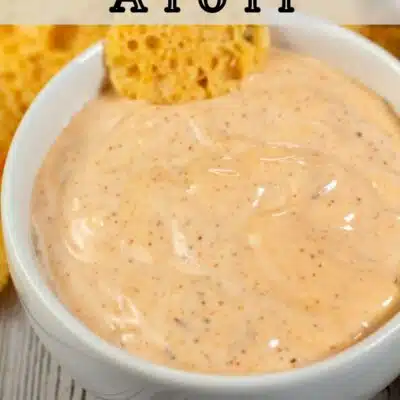Pin image with text of chipotle aioli in a white bowl.