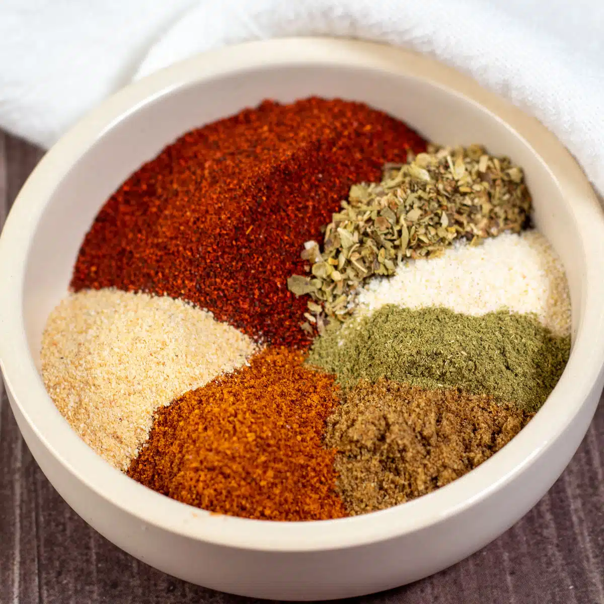 Square image of DIY chipotle seasoning in a small bowl.