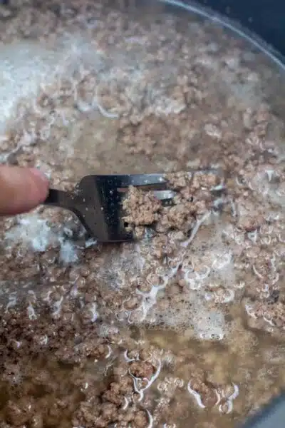 Process image 3 showing breaking up ground beef.