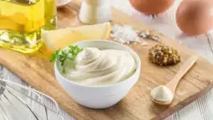 Easy homemade mayonnaise recipe with my just made mayo in a bowl with ingredients in the background.