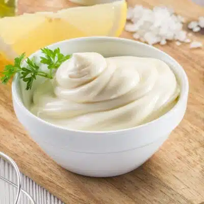 Creamy, delicious, homemade mayonnaise recipe in a small white bowl.