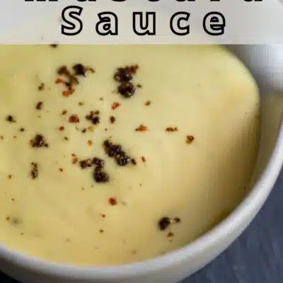 Pin image with text of honey mustard sauce in a white bowl.