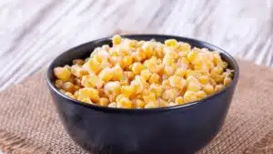 Wide image of frozen corn in a bowl.